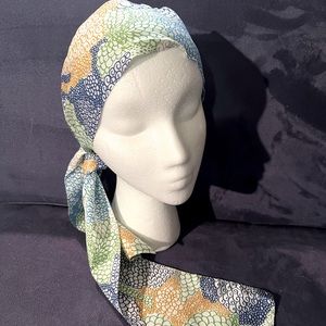 Unique vintage head scarf patterned w/ orange, green, blue, turquoise, & gray.